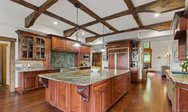 Large Kitchen Island with gorgeous stone as well as counters and backsplashes