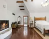 Primary Bedroom with wood burning fireplace and view of Primary Bath