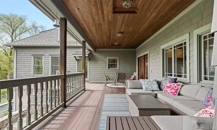 Covered Porch over patio with doors to living room, primary and kitchen