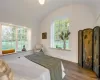 Bedroom with hardwood with barrel vaulted ceiling and window seats