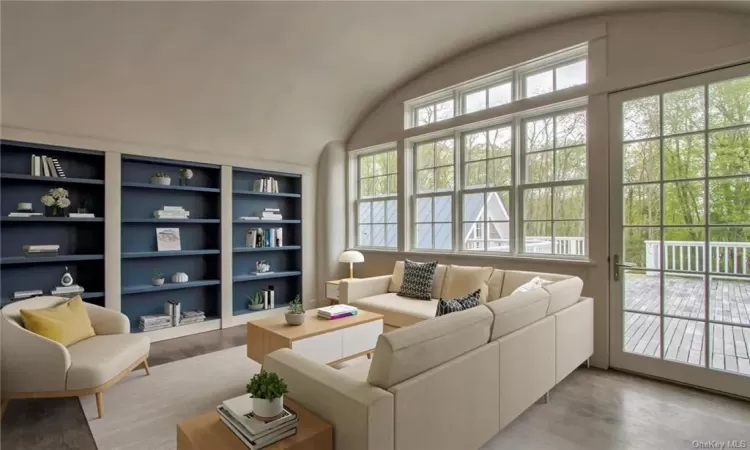 2nd floor family room w/ barrel vaulted ceiling, bookshelves & TV lift; virtually staged