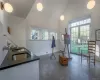 Studio space with cathedral ceiling, sink, and French doors