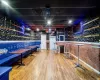 Recreation room with bar area and hardwood / wood-style flooring