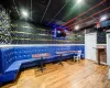 Recreation room with bar area and hardwood / wood-style flooring