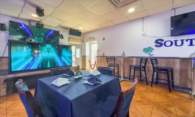 Recreation room with bar area and hardwood / wood-style flooring