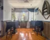 Recreation room with bar area and hardwood / wood-style flooring