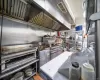 Kitchen featuring stainless steel counters and range with two ovens