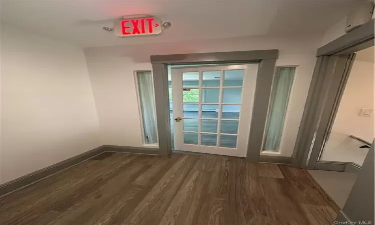 Spare room featuring dark wood-type flooring