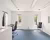 Carpeted office space with plenty of natural light