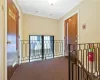 Corridor featuring ornamental molding and carpet