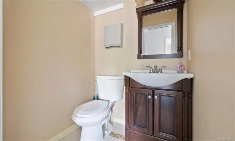 Bathroom with tile floors, vanity, and toilet