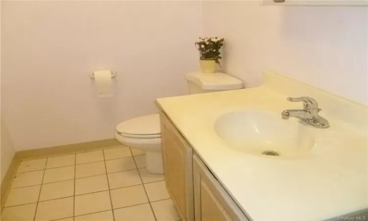 Bathroom with tile flooring, toilet, and vanity