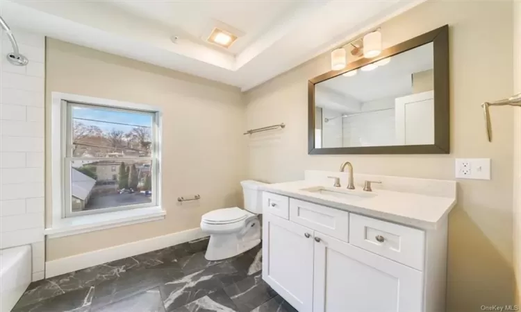 Full bathroom featuring shower / tub combination, tile floors, vanity, and toilet