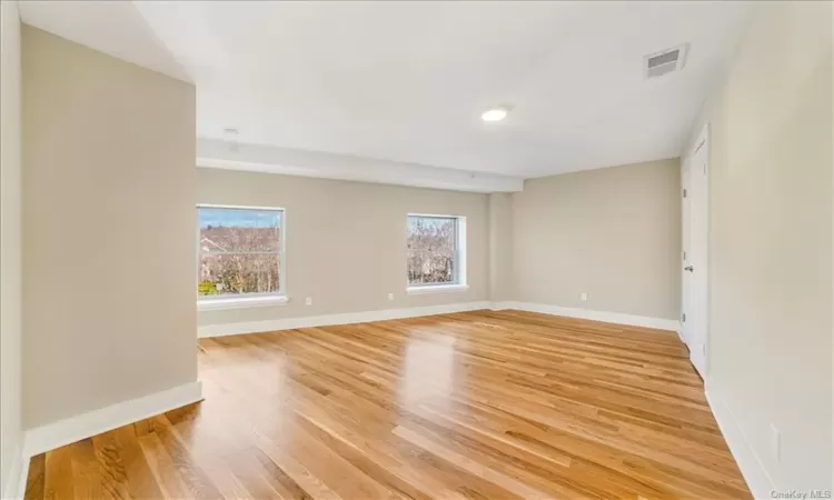 Spare room with plenty of natural light and light hardwood / wood-style floors