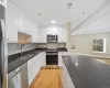 Kitchen featuring white cabinetry, stainless steel appliances, light hardwood / wood-style flooring, and sink