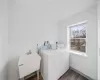 Laundry room featuring washing machine and dryer, plenty of natural light, sink, and dark hardwood / wood-style flooring