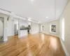 Unfurnished living room with sink and light wood-type flooring