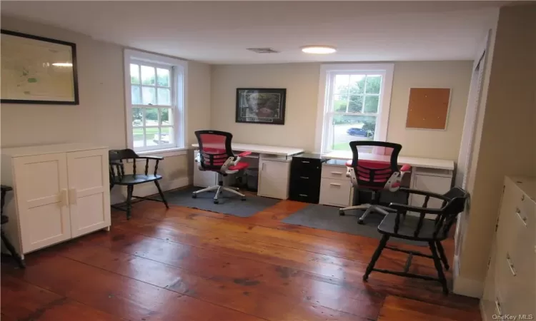 Office space with dark wood-type flooring