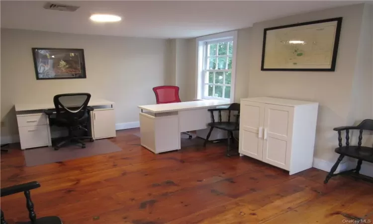 Office space featuring dark hardwood / wood-style floors