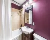 Full bathroom featuring crown molding, toilet, shower / bathtub combination with curtain, and vanity