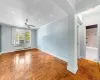 Empty room with parquet floors, ceiling fan, and radiator