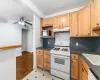 Kitchen featuring white appliances, light parquet floors, sink, tasteful backsplash, and ceiling fan