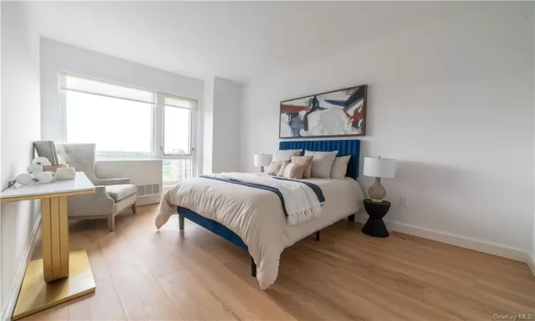 Bedroom with light hardwood / wood-style floors