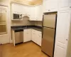 Not your typical galley or kitchenette.  Abundant cabinetry, countertop space, refrigerator, microwave and a dishwasher.  Swing door on the left leads to the bathroom.