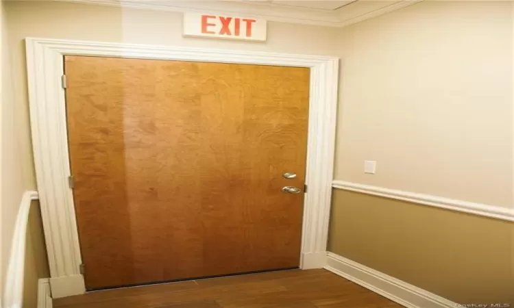 Rear exit door leads back to main lobby area.