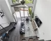 Living room with a towering ceiling, plenty of natural light, and ceiling fan