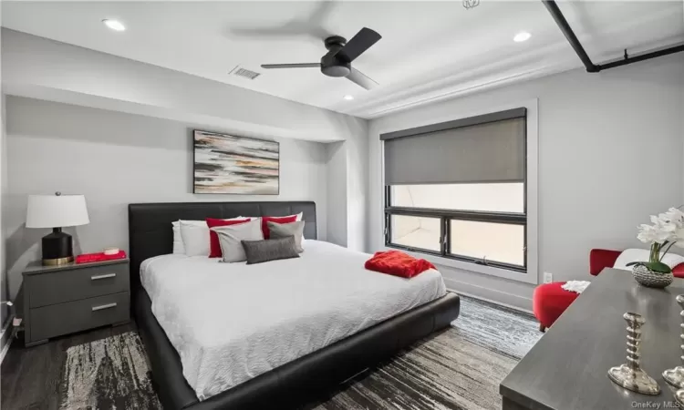 Bedroom featuring dark wood-type flooring and ceiling fan