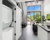 Living room with stacked washer / dryer and dark wood-type flooring