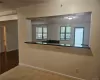 Kitchen with kitchen peninsula, a wealth of natural light, and light tile patterned floors