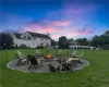 Yard at dusk with an outdoor fire pit