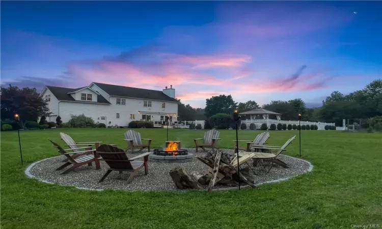 Yard at dusk with an outdoor fire pit