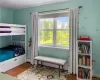 Bedroom featuring hardwood / wood-style floors and a baseboard radiator