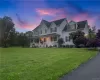 View of front facade with a yard and covered porch