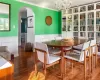 Dining space with an inviting chandelier, hardwood / wood-style floors, and crown molding