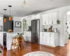 Kitchen featuring beverage cooler, white cabinets, high end fridge, and dark wood-type flooring