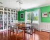 Dining space featuring a baseboard heating unit, ornamental molding, hardwood / wood-style floors, and a chandelier