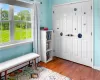 Living area with a baseboard heating unit and hardwood / wood-style flooring