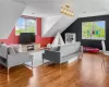 Living room featuring a wealth of natural light, lofted ceiling, and wood-type flooring