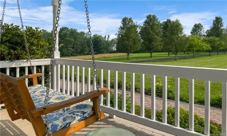 Wooden terrace featuring a lawn