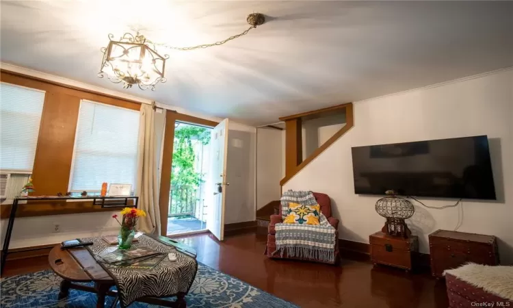 Living room featuring a chandelier and dark wood-type flooring