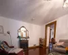 Living room with dark wood-type flooring and crown molding