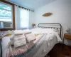 Bedroom featuring crown molding and wood-type flooring