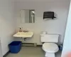 Bathroom featuring sink, tile flooring, baseboard heating, and toilet