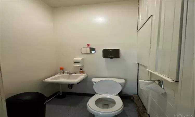 Bathroom featuring tile flooring, sink, and toilet