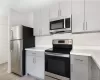 Kitchen featuring light hardwood / wood-style flooring, gray cabinetry, and stainless steel appliances