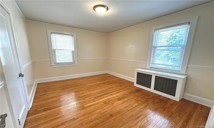 Spare room with light hardwood / wood-style flooring and radiator